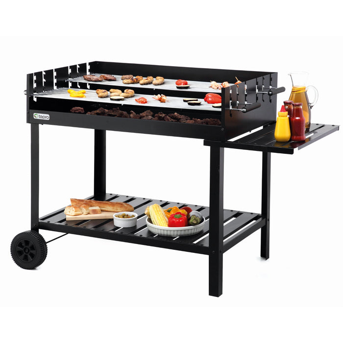 Tepro Atlanta Charcoal BBQ Trolley Grill with meat and vegetables grilling on top of it with condiments and side dishes resting on the attached side table