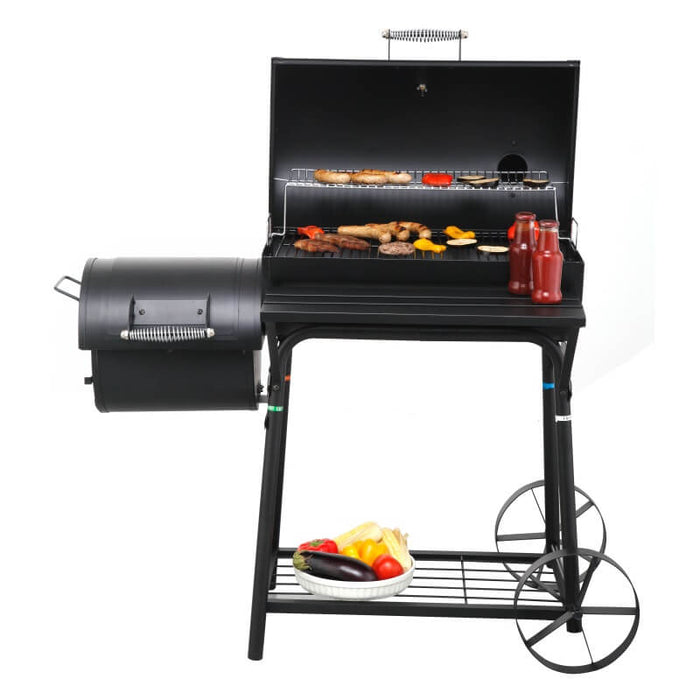 Front view of Tepro Biloxi Offset BBQ Smoker with meat and vegetables grilling on it and condiments resting on the side table