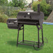 Tepro Biloxi Offset BBQ Smoker with lid closed in a garden