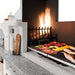 Close up of Burning Wood Fired grill of a Palazzetti Antille Complete Outdoor BBQ Kitchen cooking fish and vegetables